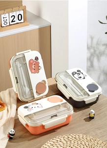 Detail view of cartoon 3-compartment lunch box with built-in utensil storage and cutlery
