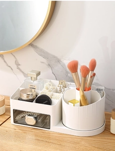 Detail of white makeup organizer with rotating brush holder and transparent drawer