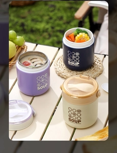 Three colorful 304 stainless steel soup jars with spoons displayed on an outdoor picnic table