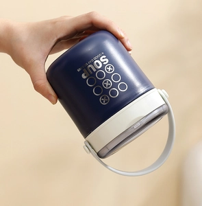 Detail of dark blue portable stainless steel soup jar with a convenient white handle