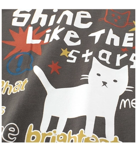 Close-up of girl's t-shirt showing cute white cat and 'Shine Like The Stars' print.