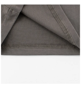 Close-up of charcoal gray knit fabric with high-quality double-needle stitching and hem