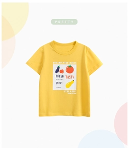 Detail of yellow cotton kids T-shirt with vibrant vegetable graphic and soft texture