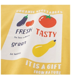 Detail of organic vegetable prints on a yellow cotton t-shirt with high-quality texture