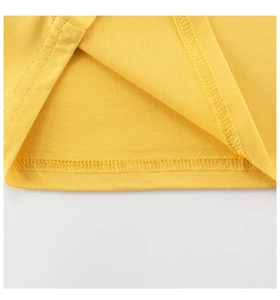 Detail of double-needle stitching and high-quality hem on yellow cotton kids T-shirt