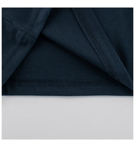 Détail macro de l'ourlet du t-shirt bleu marine en coton avec double couture précise