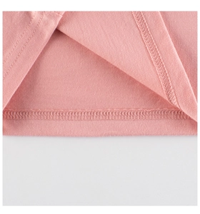 Detail of double-needle stitching and texture on a pink knitted long-sleeve cotton T-shirt