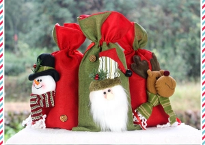 Detail of burlap Christmas gift bags with plush snowman, Santa, and reindeer figures