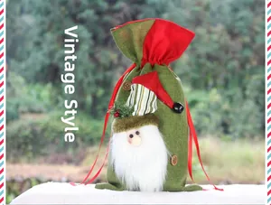 Detail of Christmas burlap gift bag with 3D Santa Claus figure and red silk drawstring