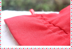 Close-up of red burlap Christmas gift bag fabric with durable hanging strap