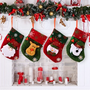 Christmas stocking set with Santa and reindeer hanging on fireplace mantle decorations