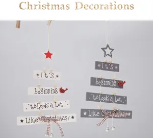 Hanging wooden Christmas tree ornaments with stars, birds, bows, and small metal bells