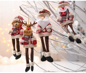 Detail view of plush Christmas tree hanging ornaments with long legs and plaid scarves