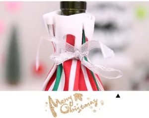 Detail of red and green striped Christmas wine bottle cover with silver glitter ribbon tie