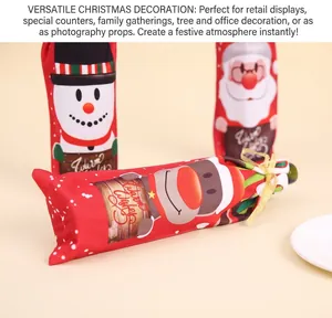 Close-up of festive Christmas wine bottle covers with Santa and snowman patterns