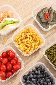 Set of six clear plastic food containers showing versatile storage for various fresh ingredients