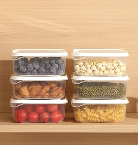 Macro detail of stackable clear food storage containers with airtight white lids for pantry
