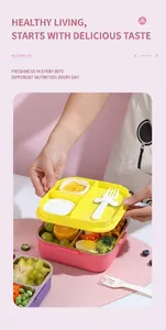 Detailed view of pink three-compartment stainless steel bento box with yellow lid and fork