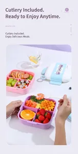 Divided lunch box with utensils shown packed with meat, fruit and fresh waffles