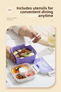 Detail of double-layer lunch box with pink inner divider and portable utensils