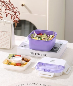 Detail of multi-layer lunch box with purple food containers and white cutlery lid
