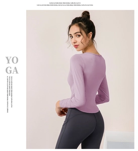 Slim fit lavender long sleeve yoga top featuring a scoop neck and high-stretch fabric detail