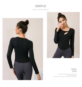 Detail of black long-sleeve yoga top featuring stylish cutout neckline and slim fit