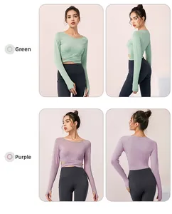 Détail du haut de yoga ajusté avec sangles croisées à la taille et passe-pouces en vert