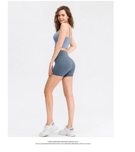 Side view of grey-blue high-waisted yoga shorts and sports bra set for fitness