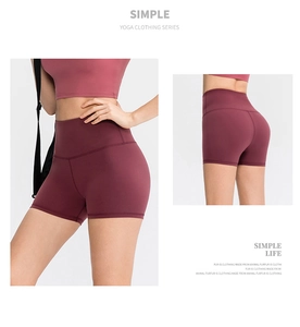 Detail of high-waist maroon yoga shorts showing elastic fabric and butt-lifting back view