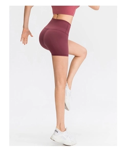 Detail view of burgundy high-waisted yoga shorts with wide seamless tummy control waistband