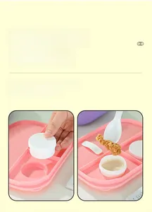 Close-up of a pink bento box compartment with a separate sealed white sauce container