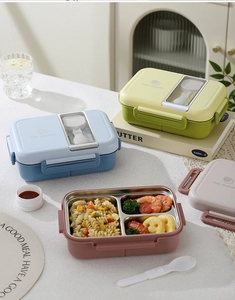 Detail view of 304 stainless steel lunch box with divided tray and folding spoon storage