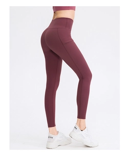 Detailweergave van de bordeauxrode yoga legging met hoge taille en handige zijzak