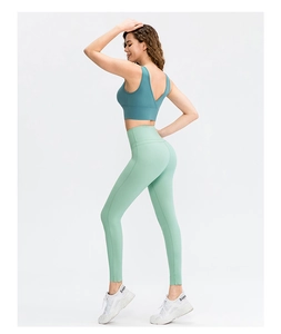 Close-up showing the fit of high-waist peacock blue and mint green seamless yoga set