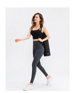 Detail of high-waist yoga leggings and sports tank top showing seamless compression fit