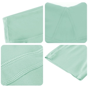 Detail view of mint green yoga pants showing reinforced seams and professional stitching