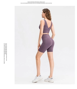 Side view of purple yoga set with high waist pocket shorts and sports bra for women