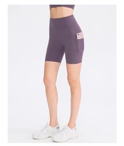 Detail of high waisted purple yoga shorts featuring functional side phone pockets