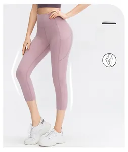 Detail of high-waisted purple yoga leggings featuring functional side pockets and slim fit