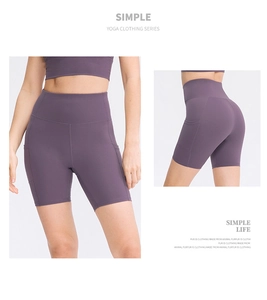 Macro detail of high-waist purple yoga shorts showing side pockets and seam structure