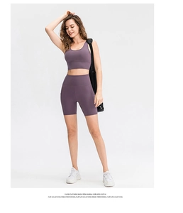 Detail view of purple yoga shorts with practical side pocket and high-waist fit