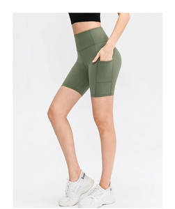 Detail view of high-waisted olive green yoga shorts with practical side pocket feature
