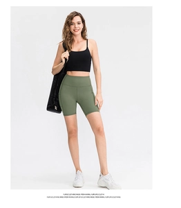 Close-up of olive green high-waisted yoga shorts with functional side pockets