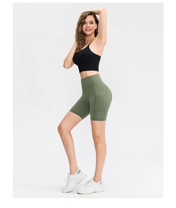 Detail view of olive green high-waist yoga shorts with functional side pockets