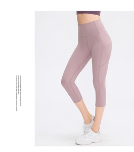 Macro detail of high-waisted yoga pants with ergonomic side pockets and stitching