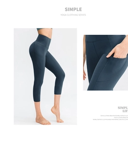 Detail view of high waist cropped yoga pants featuring side pockets and navy stretch fabric