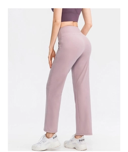 Side view of high-waisted loose yoga pants in lavender with soft moisture-wicking fabric