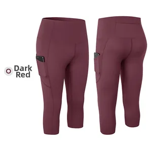 Detail of high-waist dark red yoga capris with side pockets and back zipper pocket