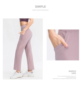 Detail of high-waisted yoga pants with side pockets in soft lavender stretch fabric